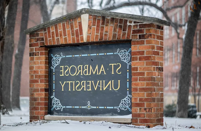 A brick sign reads St. Ambrose University.